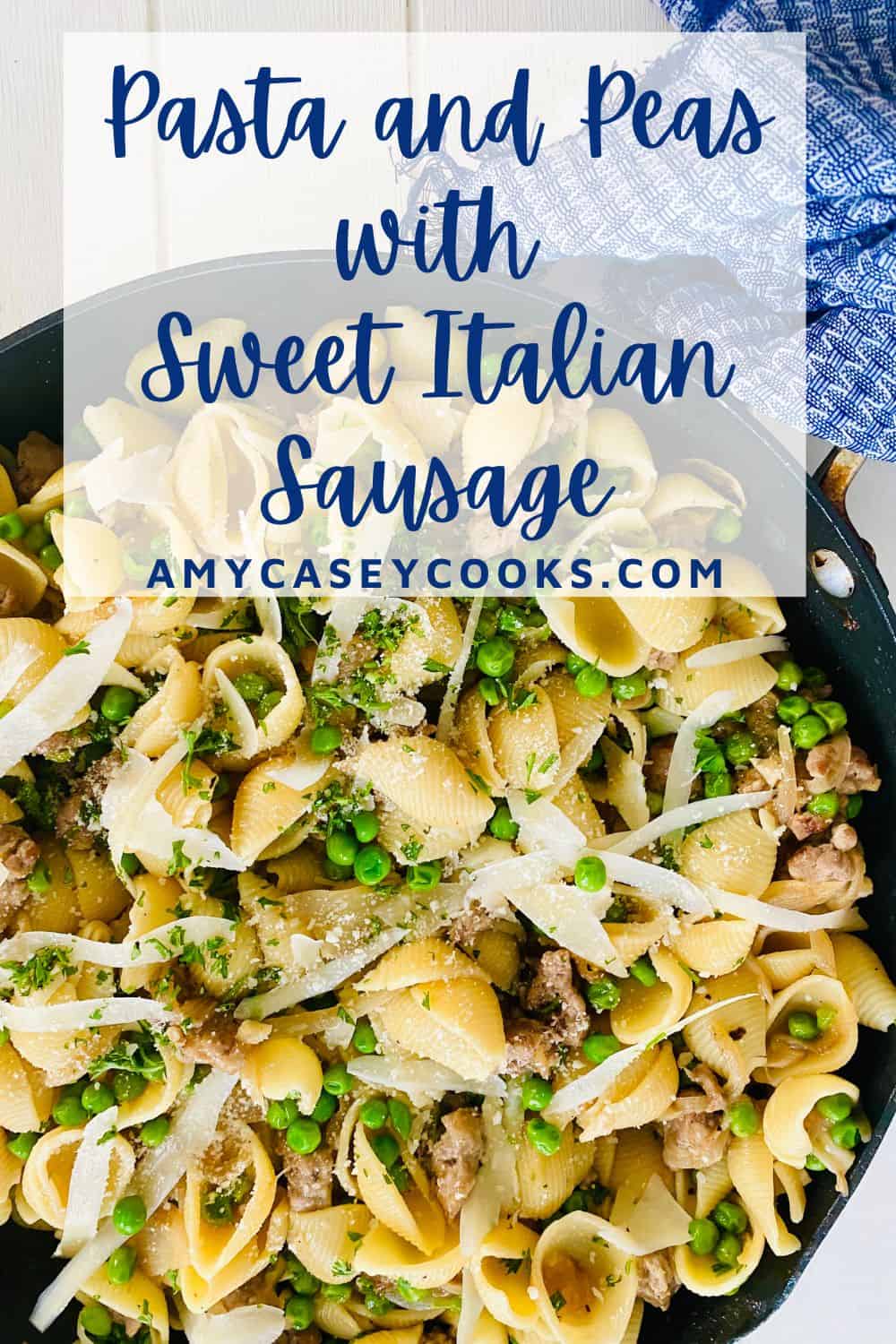 A large pan of noodles, sausage and peas.