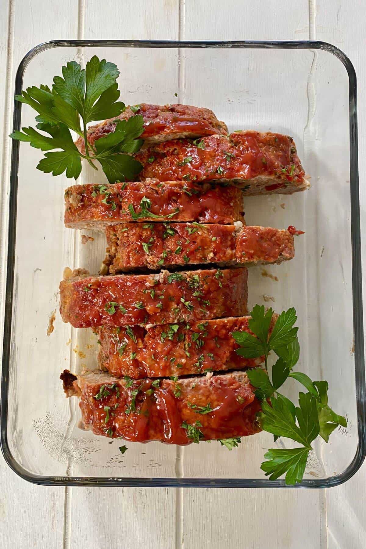 Mom's meatloaf sliced and in a glass dish.