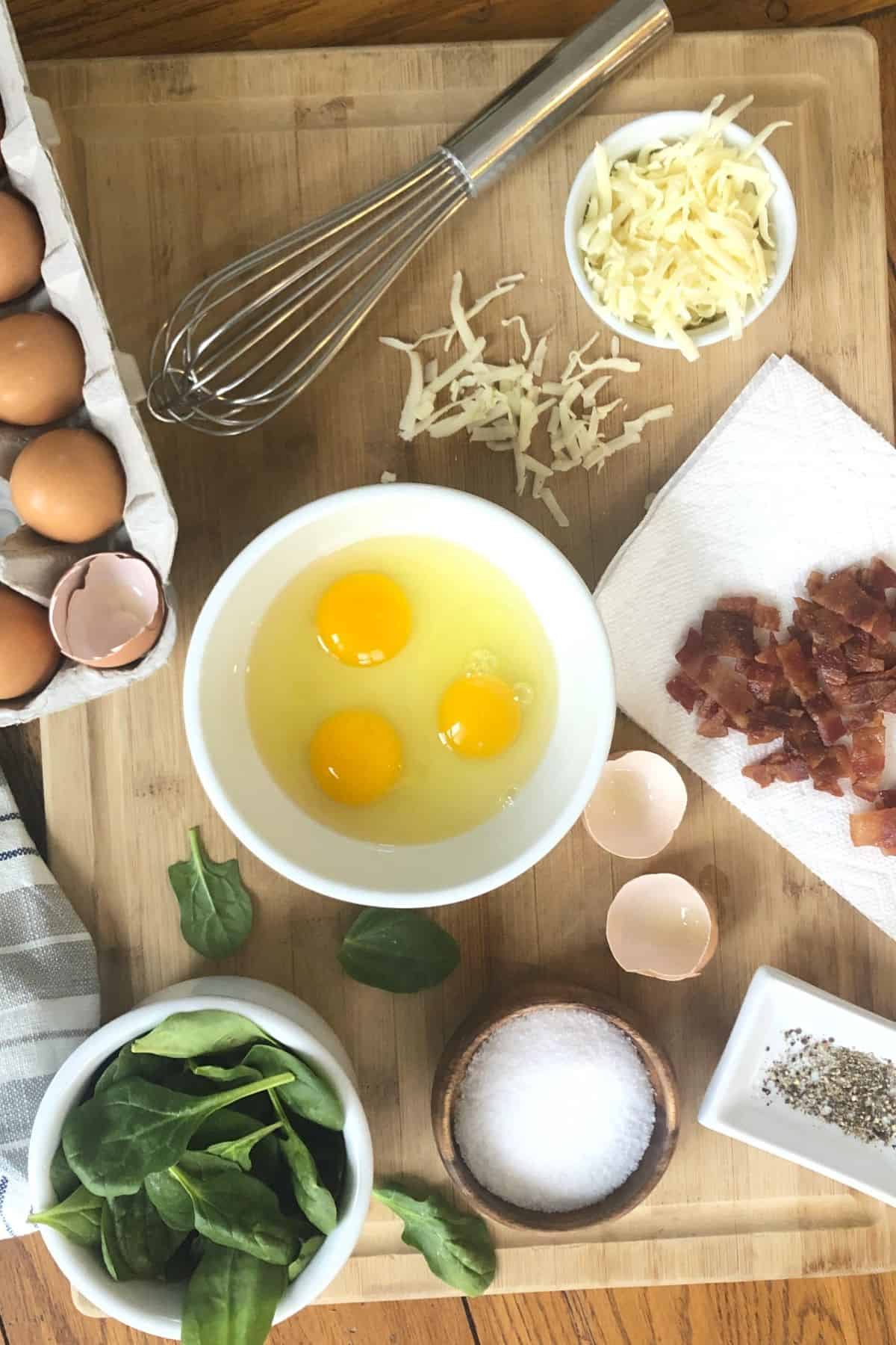 eggs, cooked bacon, shredded cheese, spinach for a crustless spinach quiche recipe.