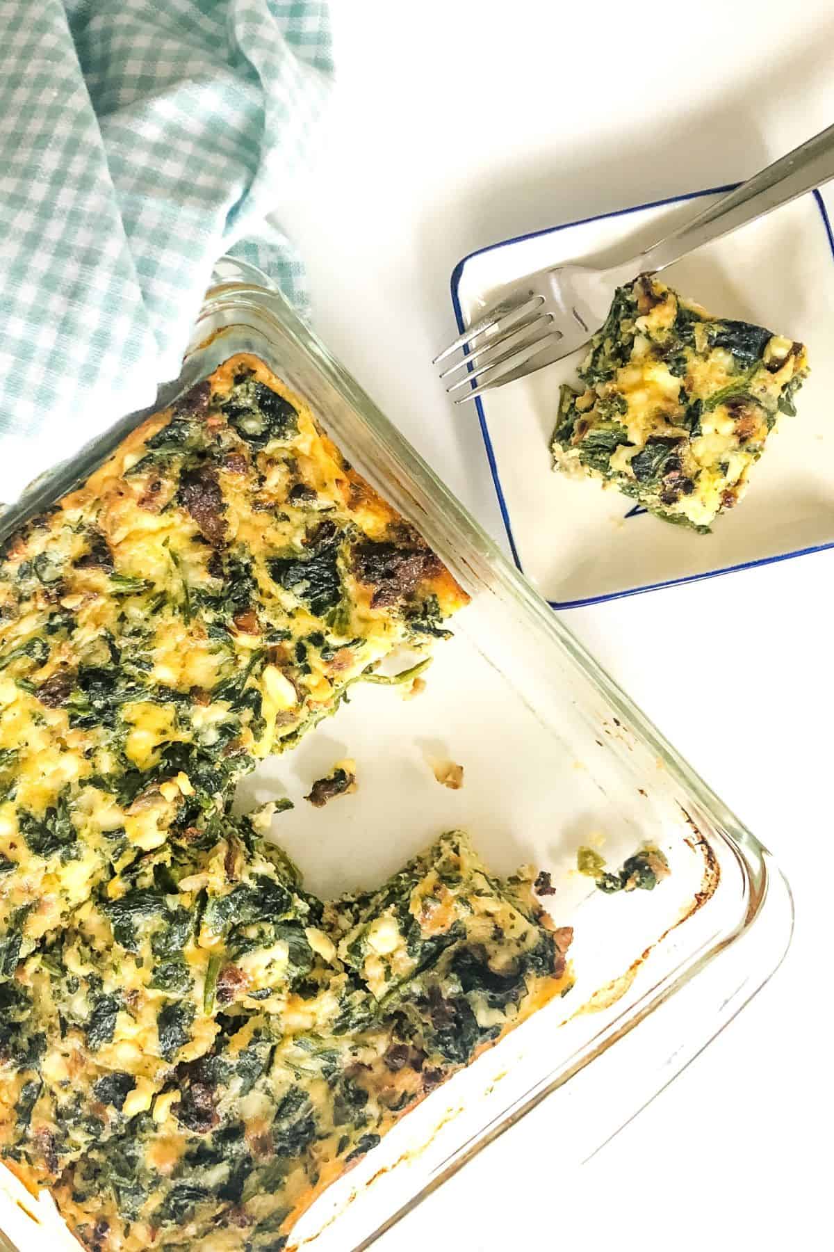 a crustless spinach quiche with slices cut out.