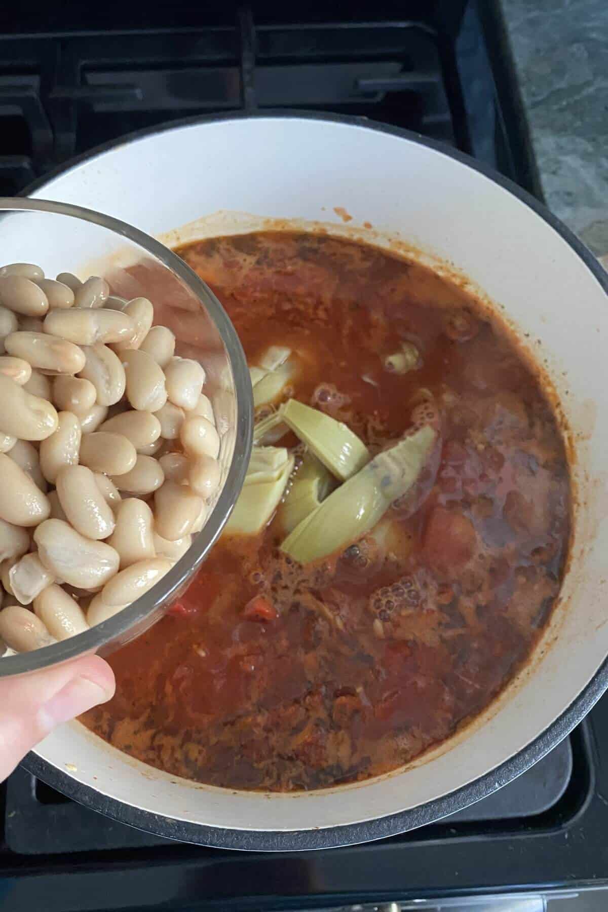 A bowl of beans and a pot of soup.