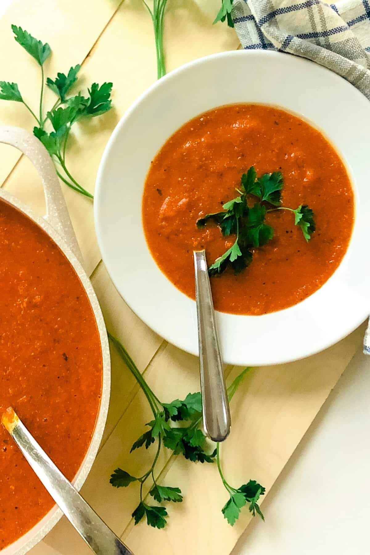 a pot and bowl of tomato soup.