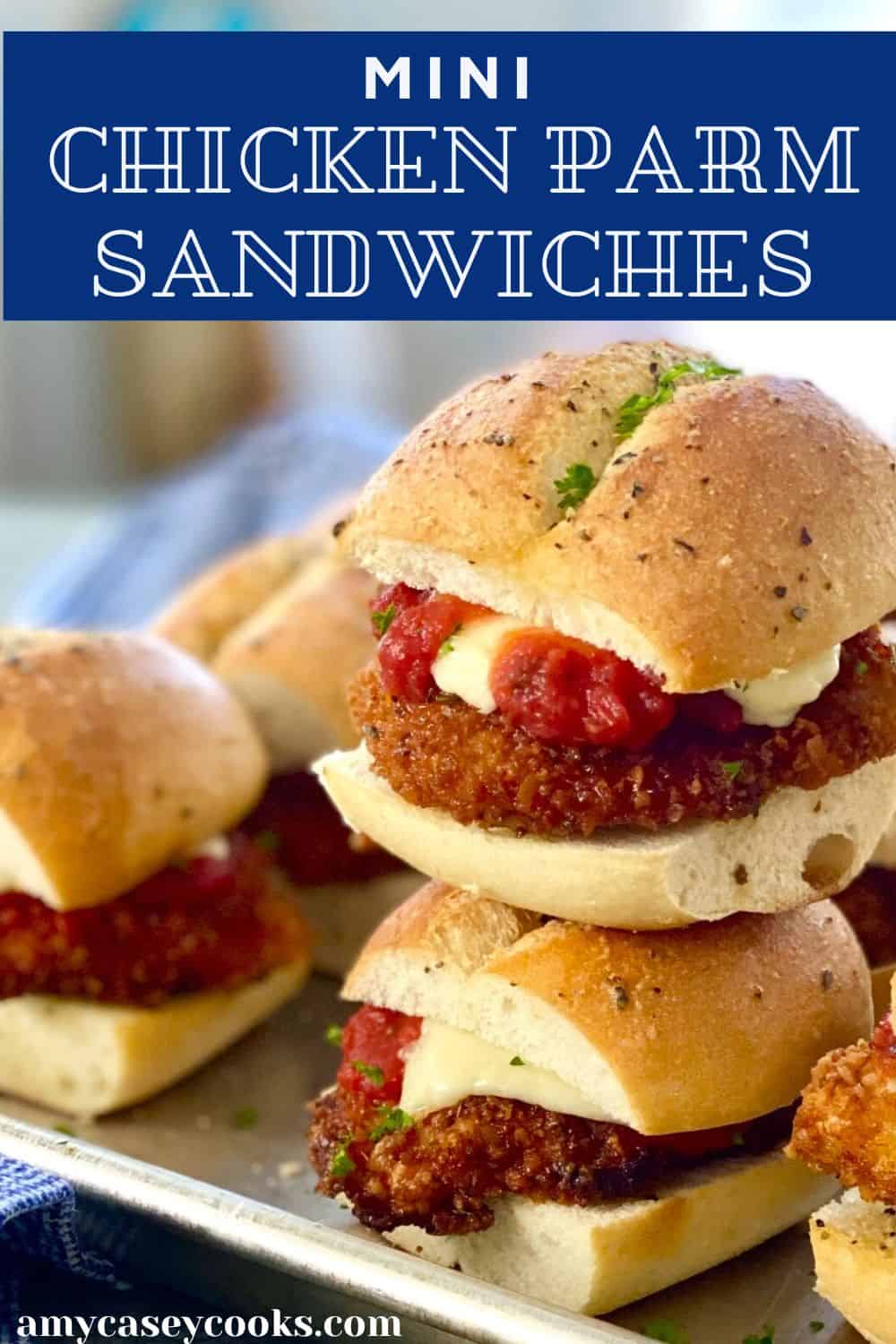 A mini chicken parm sandwiches stack on top of each other.
