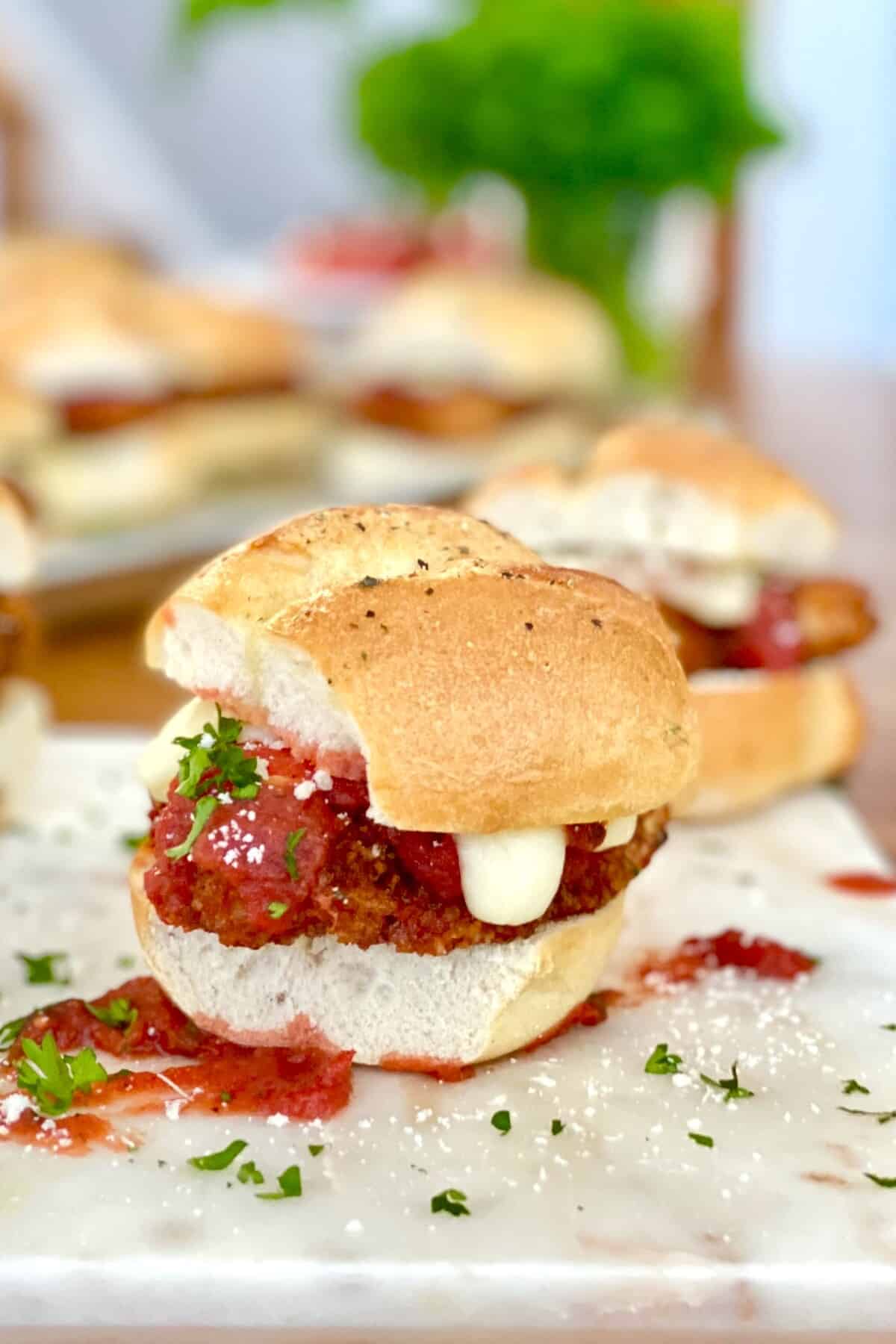 A small chicken parm sandwich with melted mozzarella cheese.