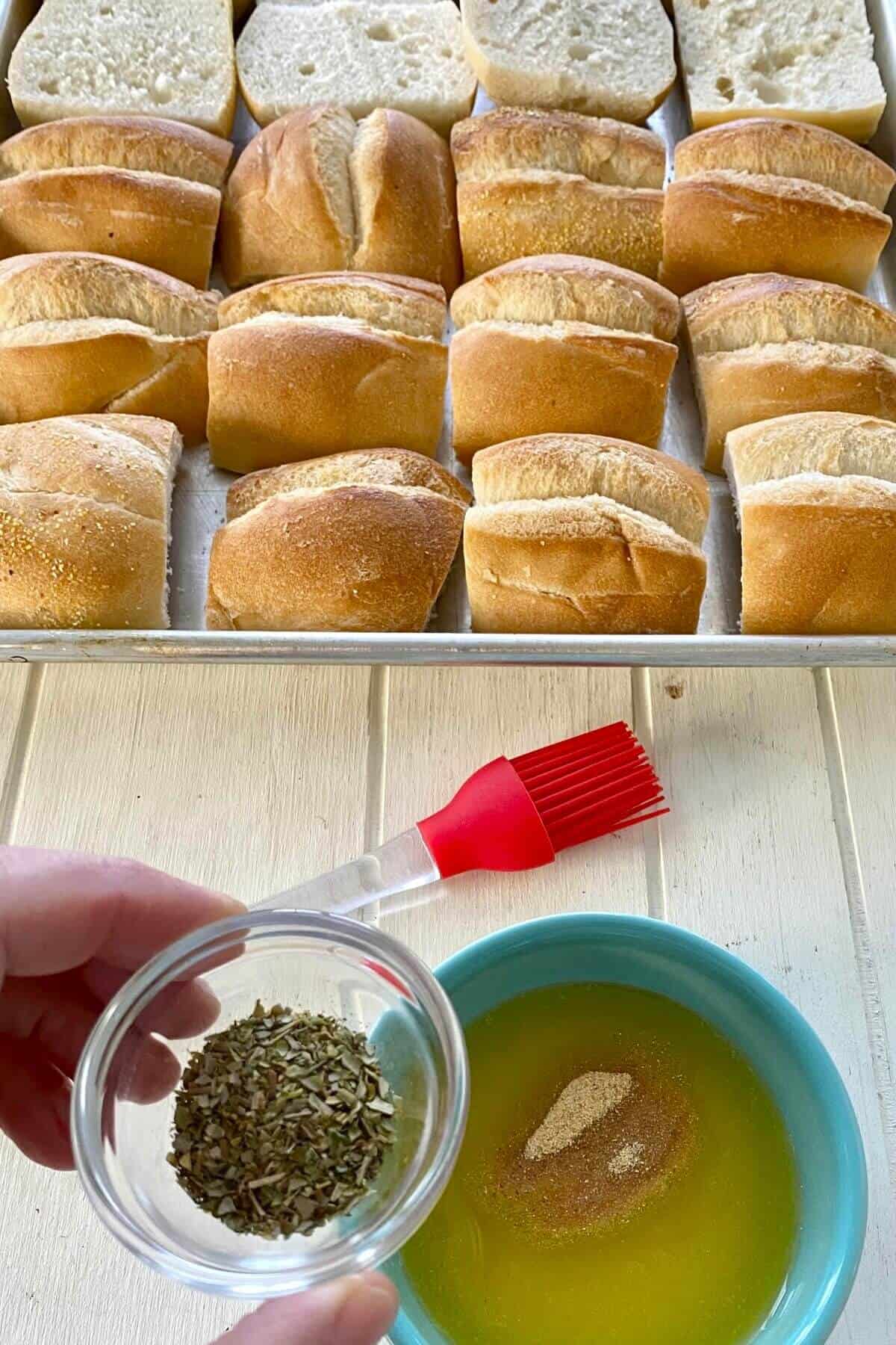 Adding dried herbs to melted butter in a bowl.