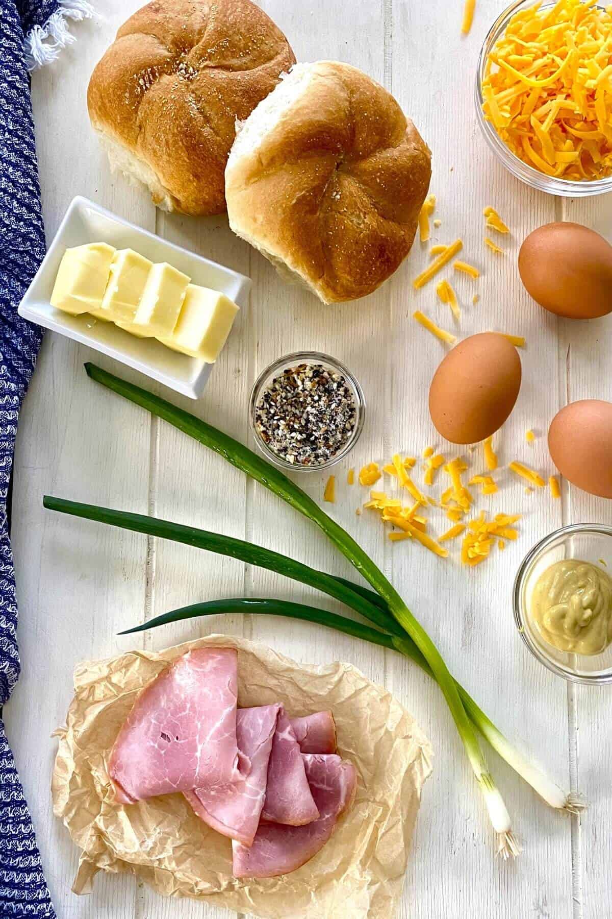 eggs, ham, shredded cheese, rolls, butter, scallions.