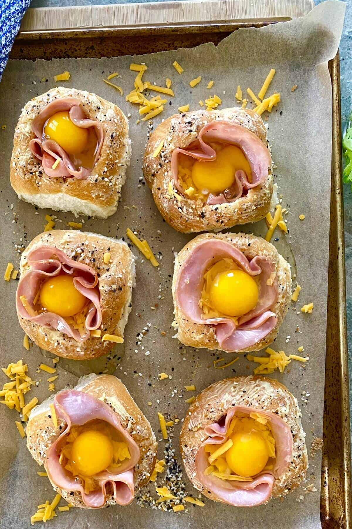 bread bowls filled with ham, cheese and egg.