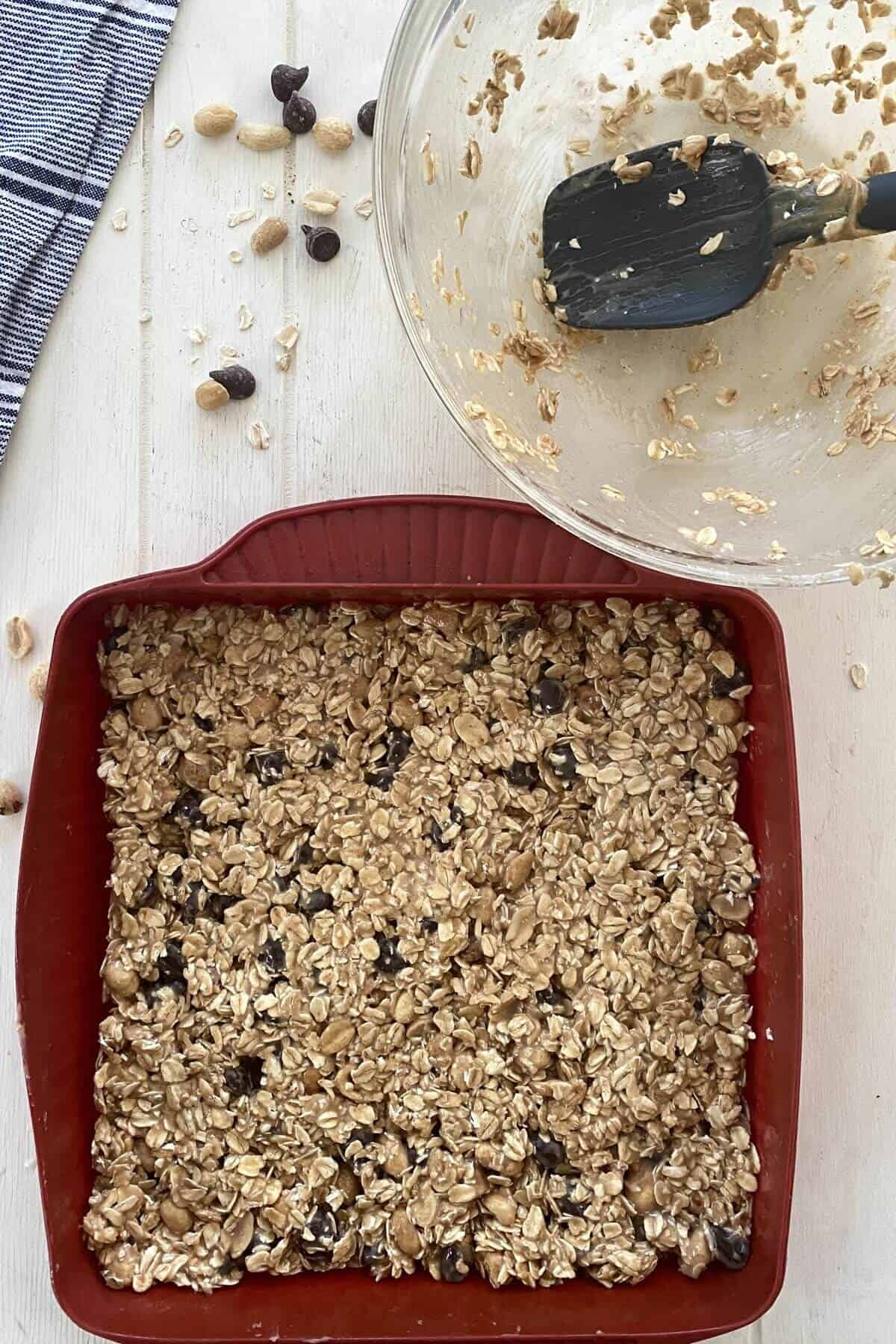 spreading oat bars in a pan.