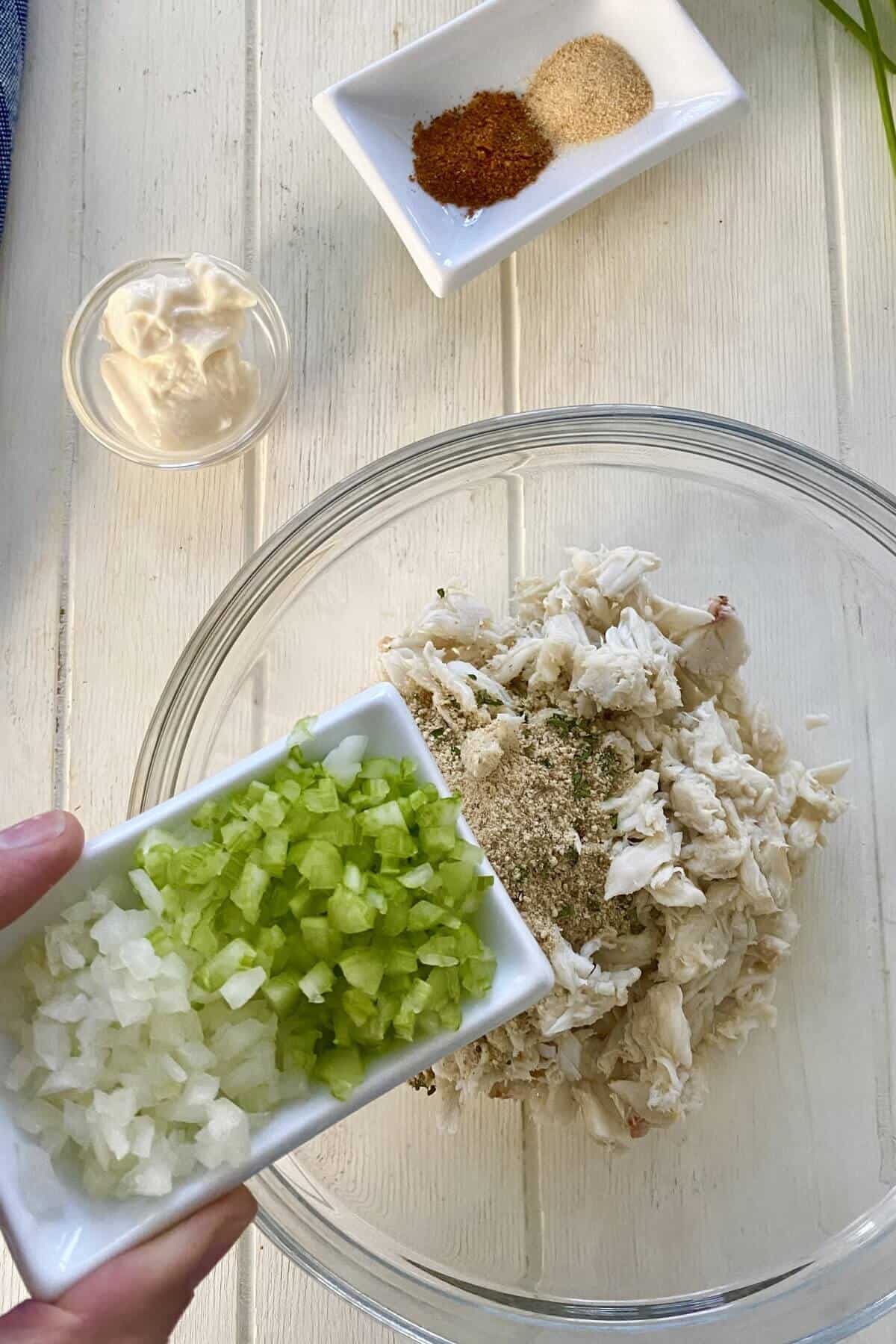 adding celery and onion to crab.
