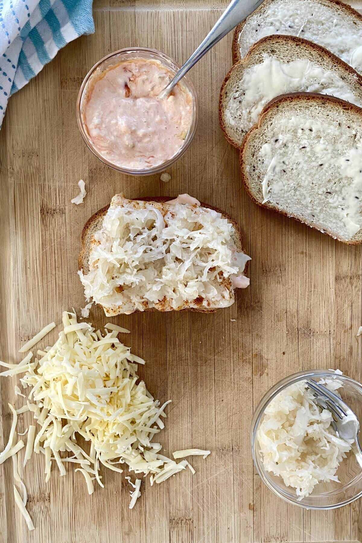 Sauerkraut on a open faced reuben sandwich with cod.