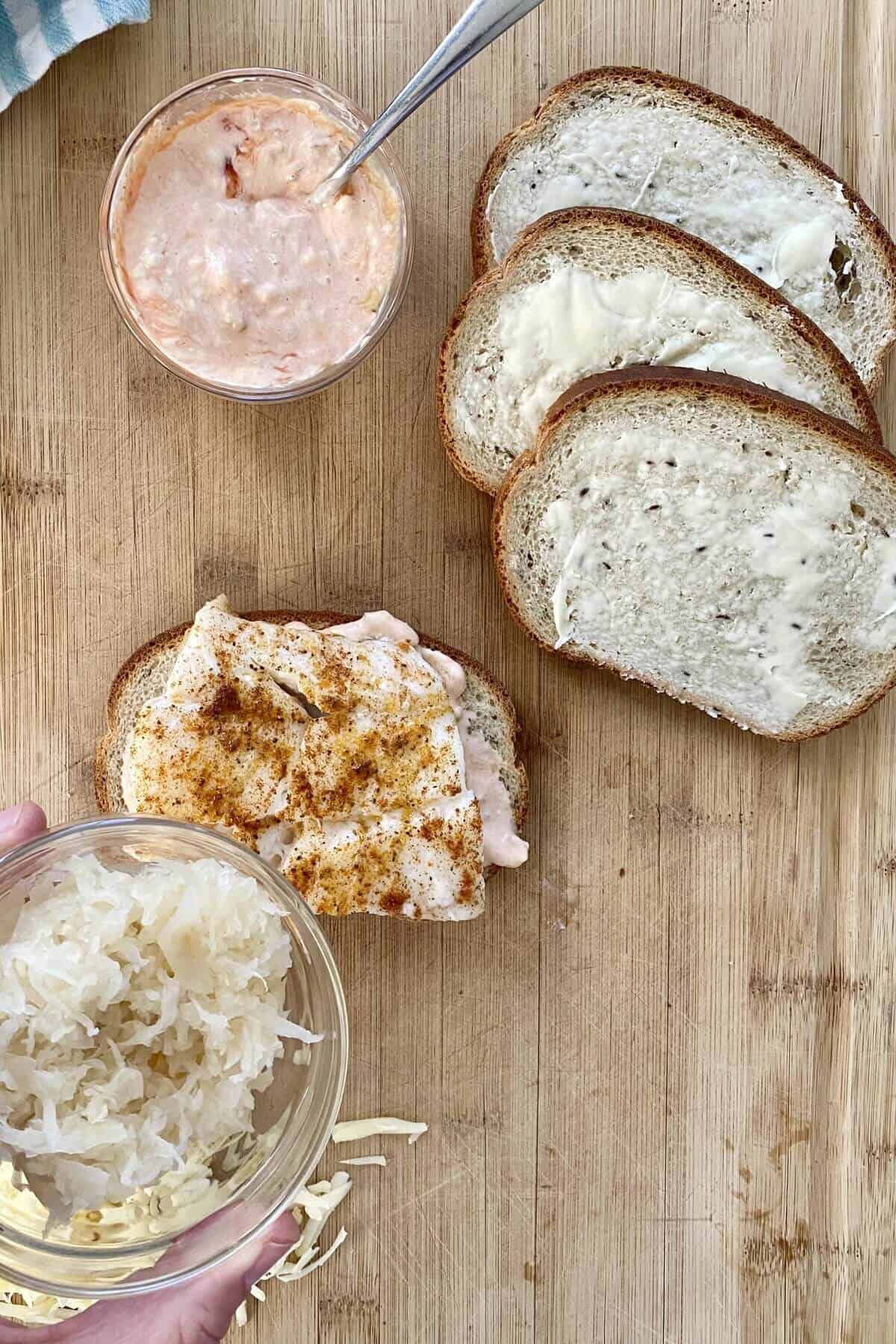A cooked piece of cod on a slice of bread.