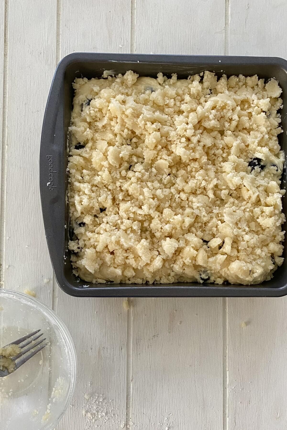 Unbaked muffin cake with crumb topping.