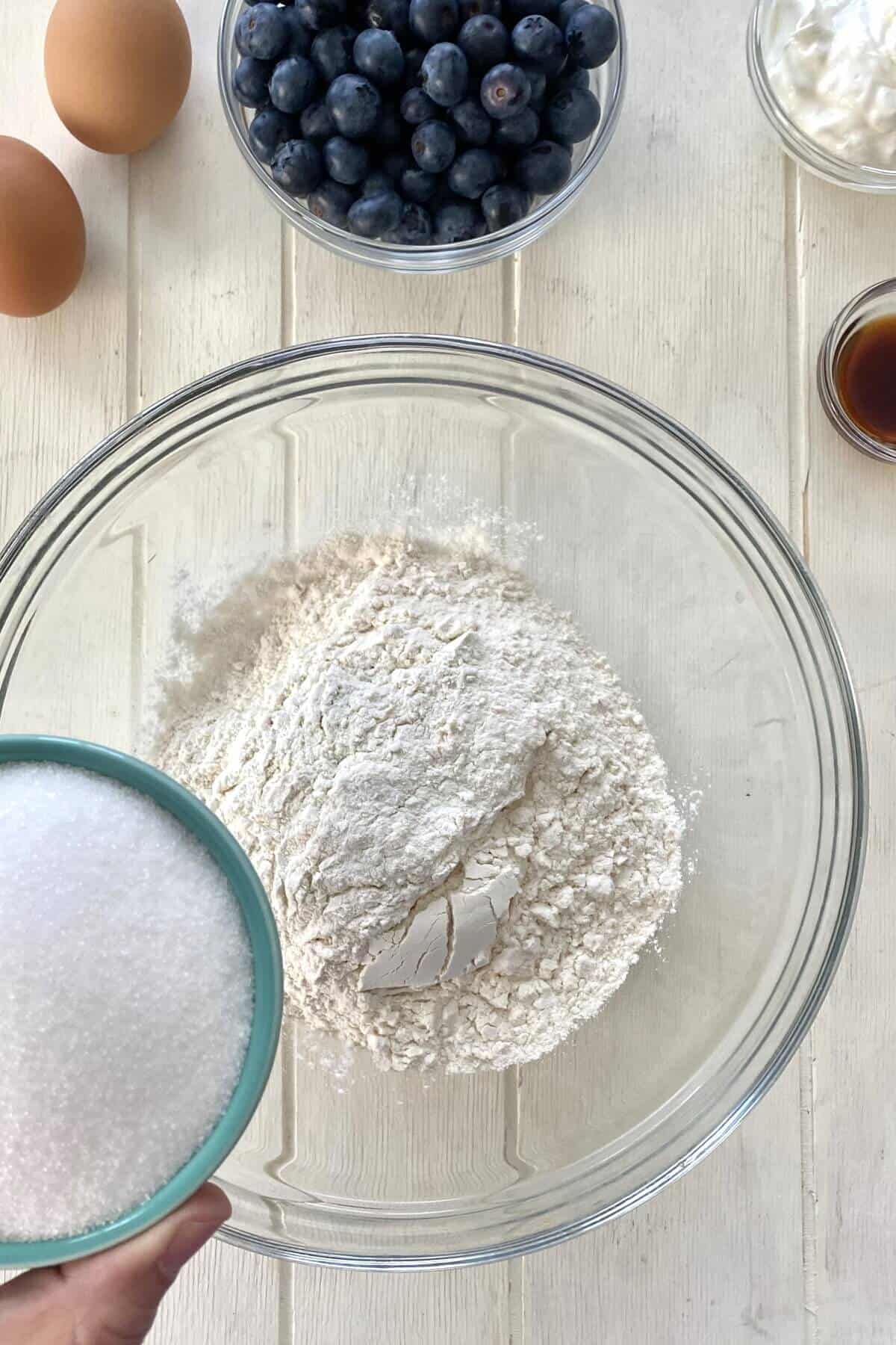 combining dry ingredients for blueberry muffin cake recipe.