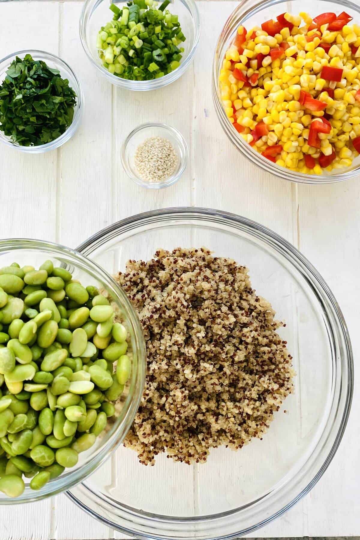 adding edamame to cooked quinoa.