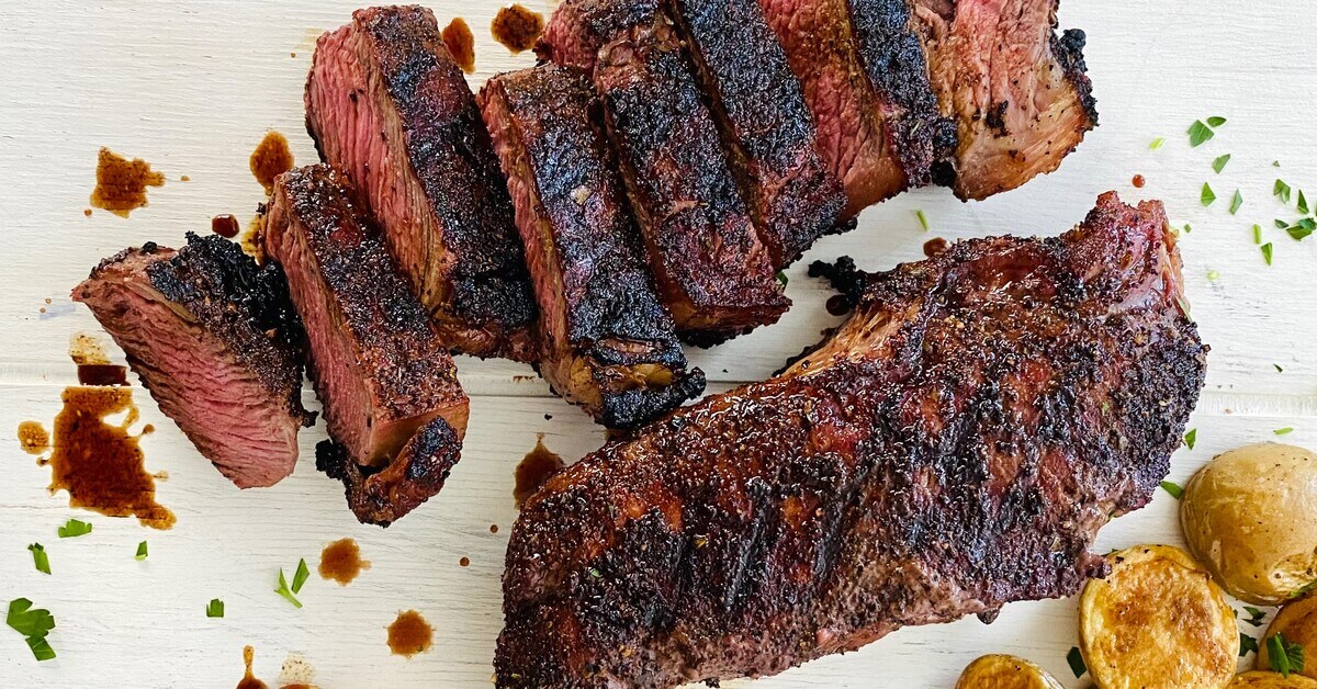 sliced coffee rubbed steak and roasted potatoes.