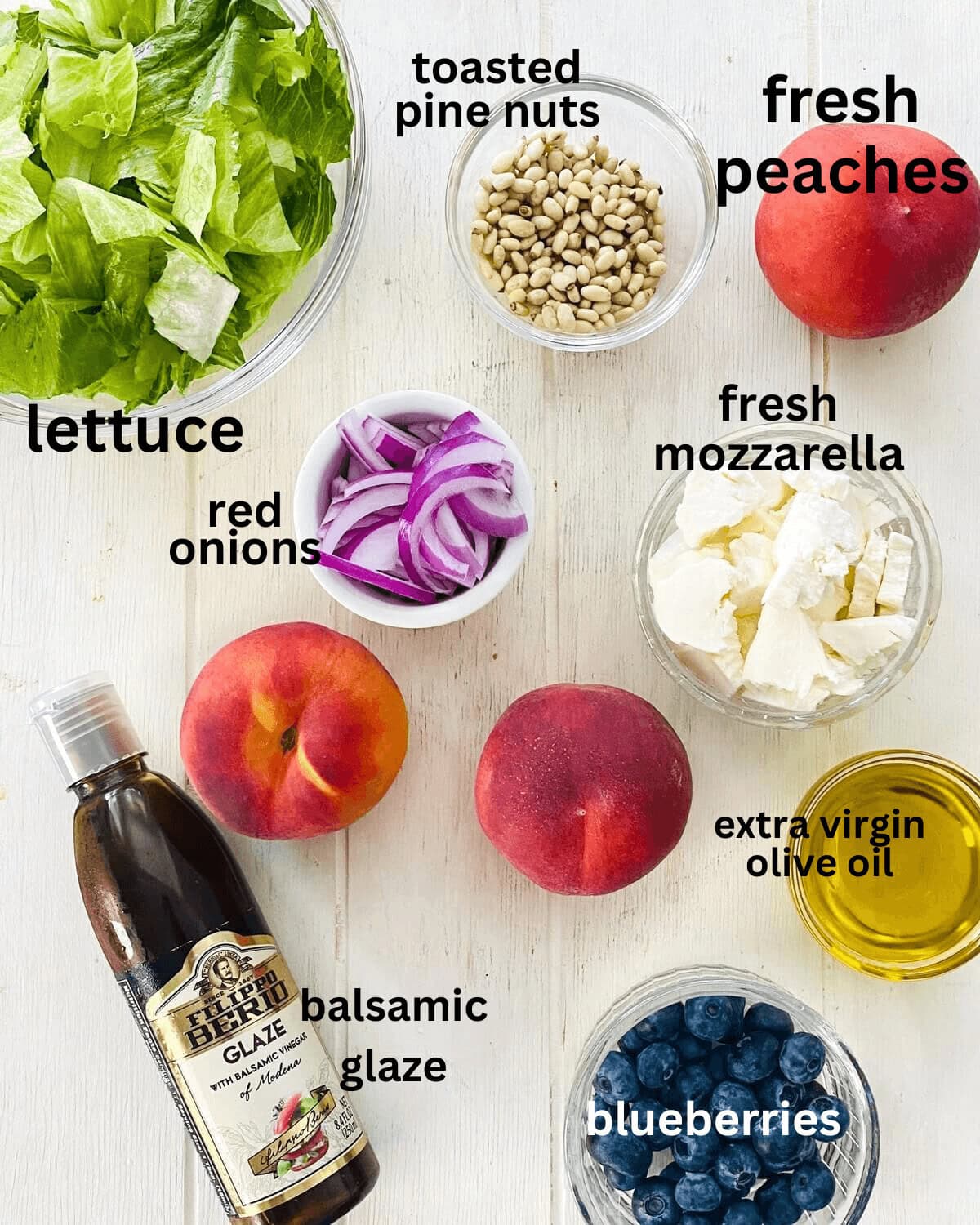 Lettuce, peaches, pine nuts, red onion, mozzarella, olive oil, blueberries, balsamic vinegar.