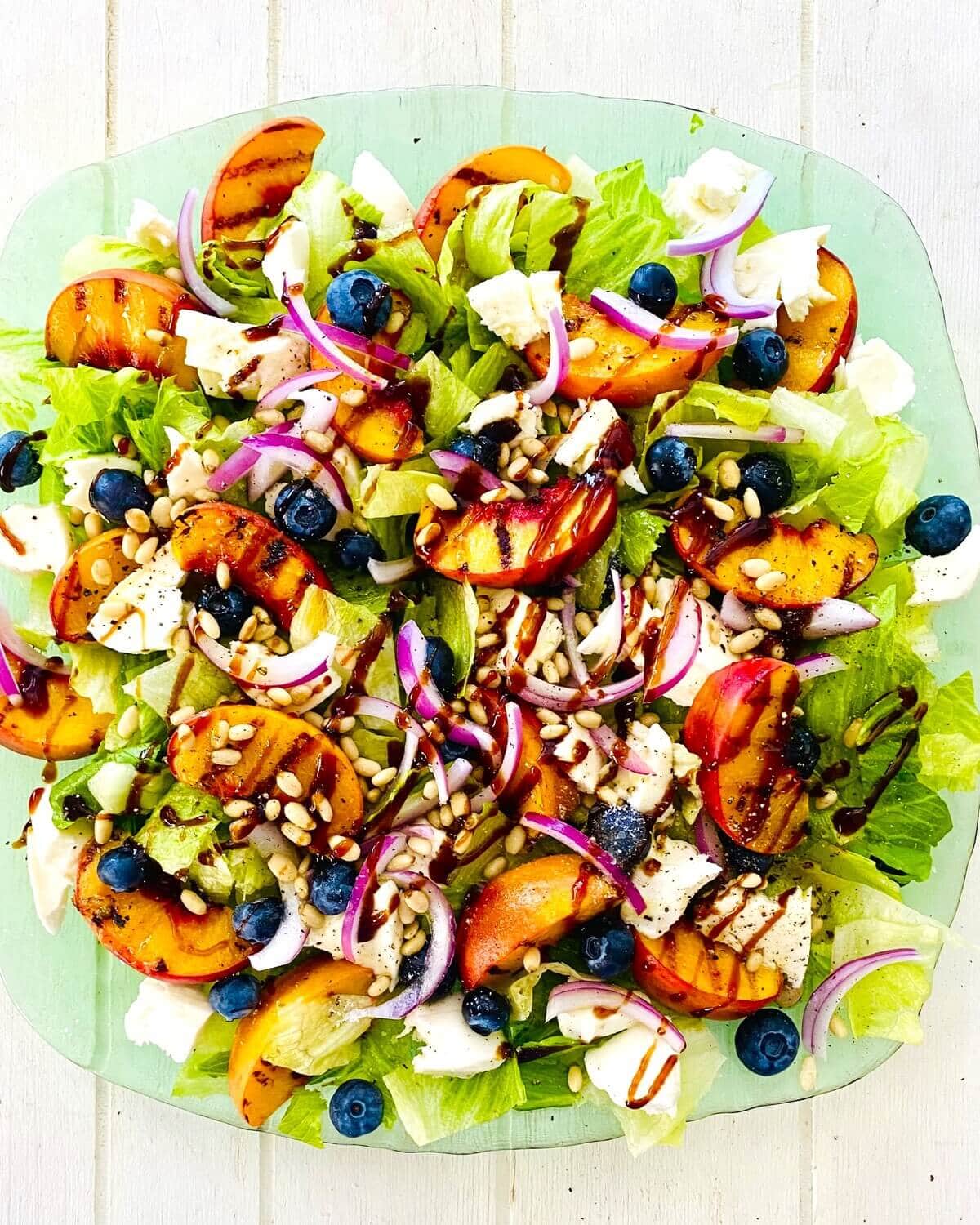 grilled peach salad with blueberries.