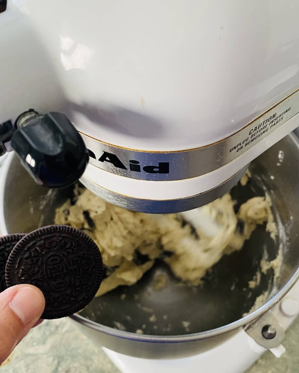adding Oreos to sugar cookie batter.