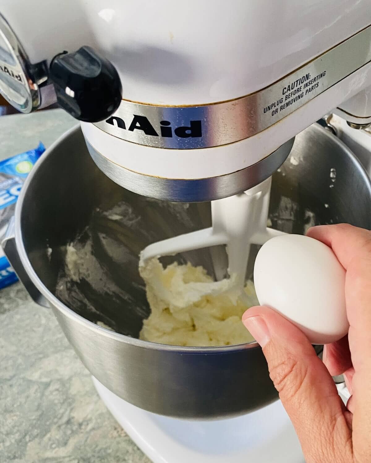 adding egg to Oreo sugar cookie batter.