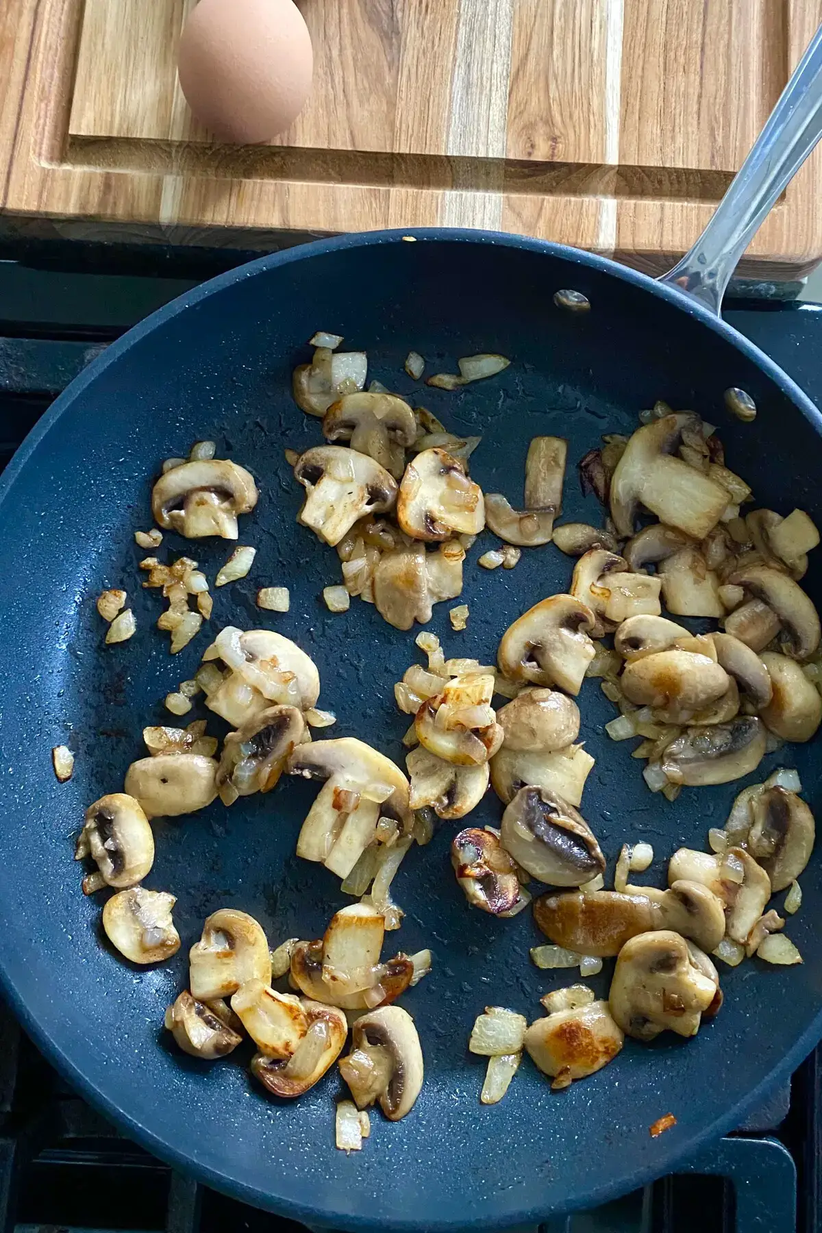 sauteed mushrooms and onions in a sauté pan.