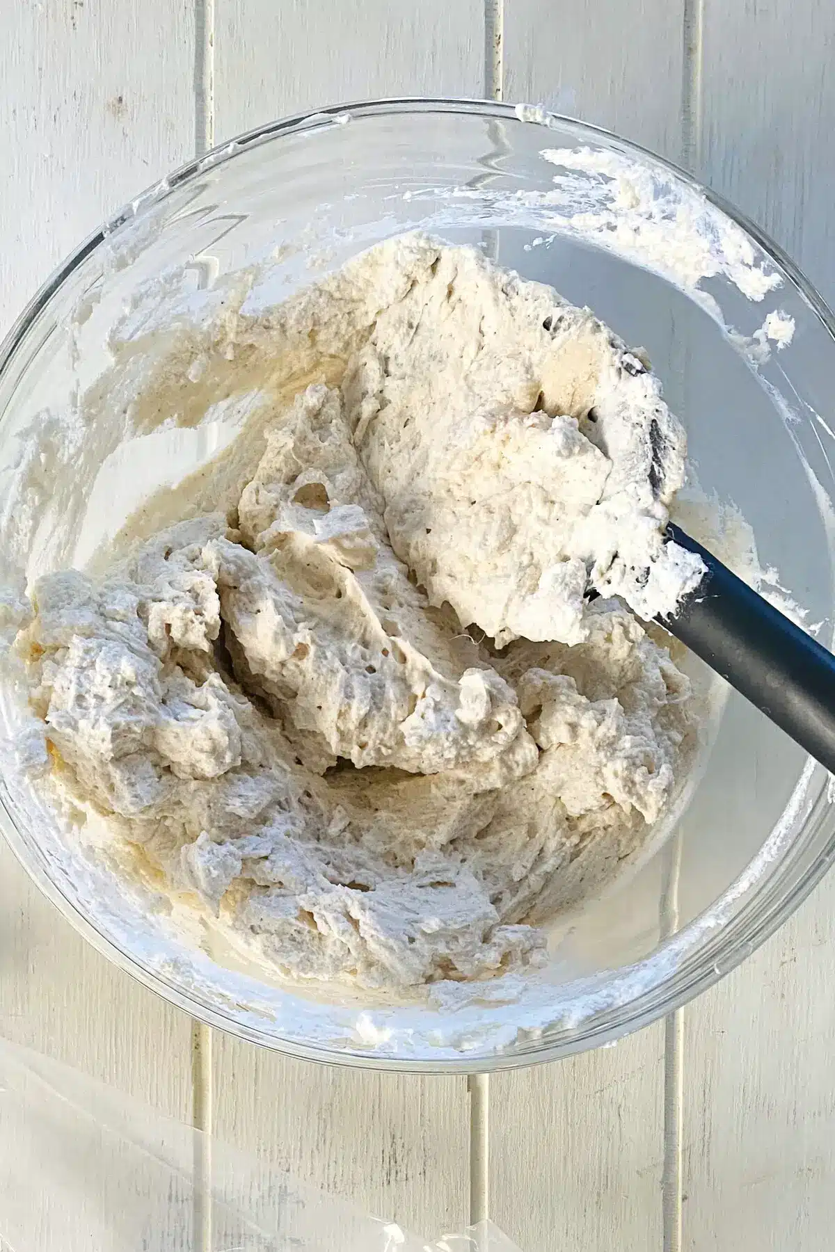 Whipped cheesecake filling in a glass bowl.