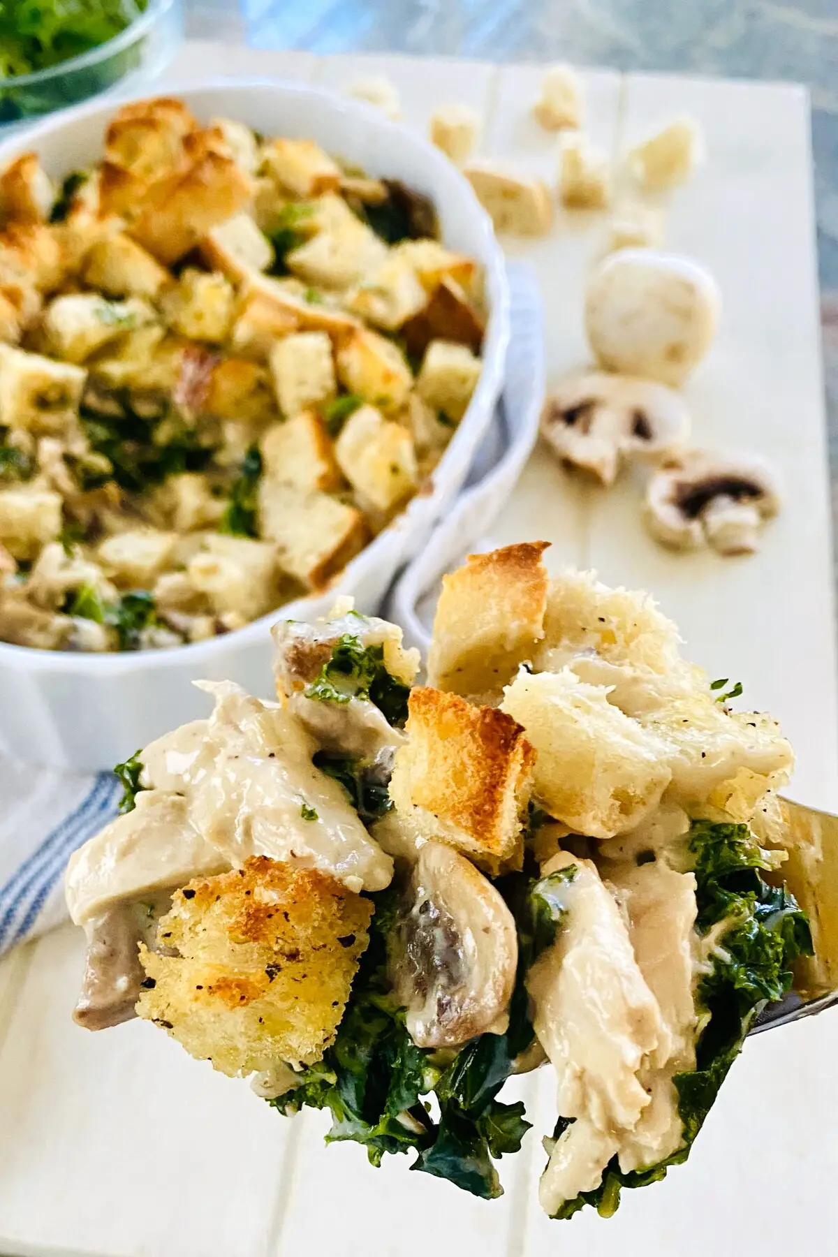 chicken and kale casserole on a spoon.