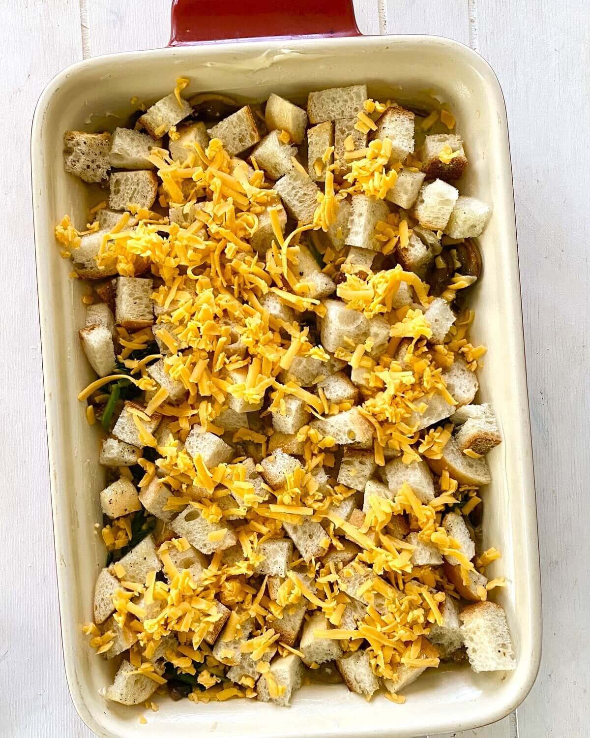 unbaked egg casserole with croutons and cheese.