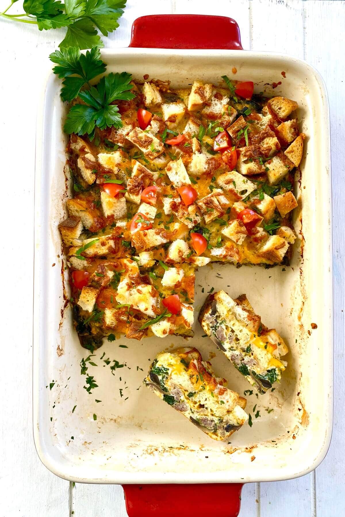 egg casserole with 2 pieces cut out.
