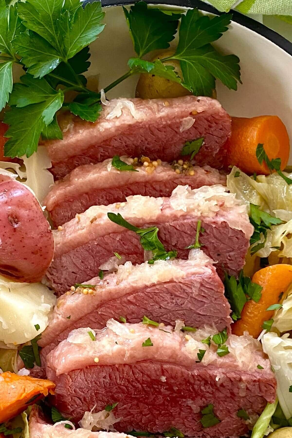 5 slices of corned beef with carrots and cabbage.