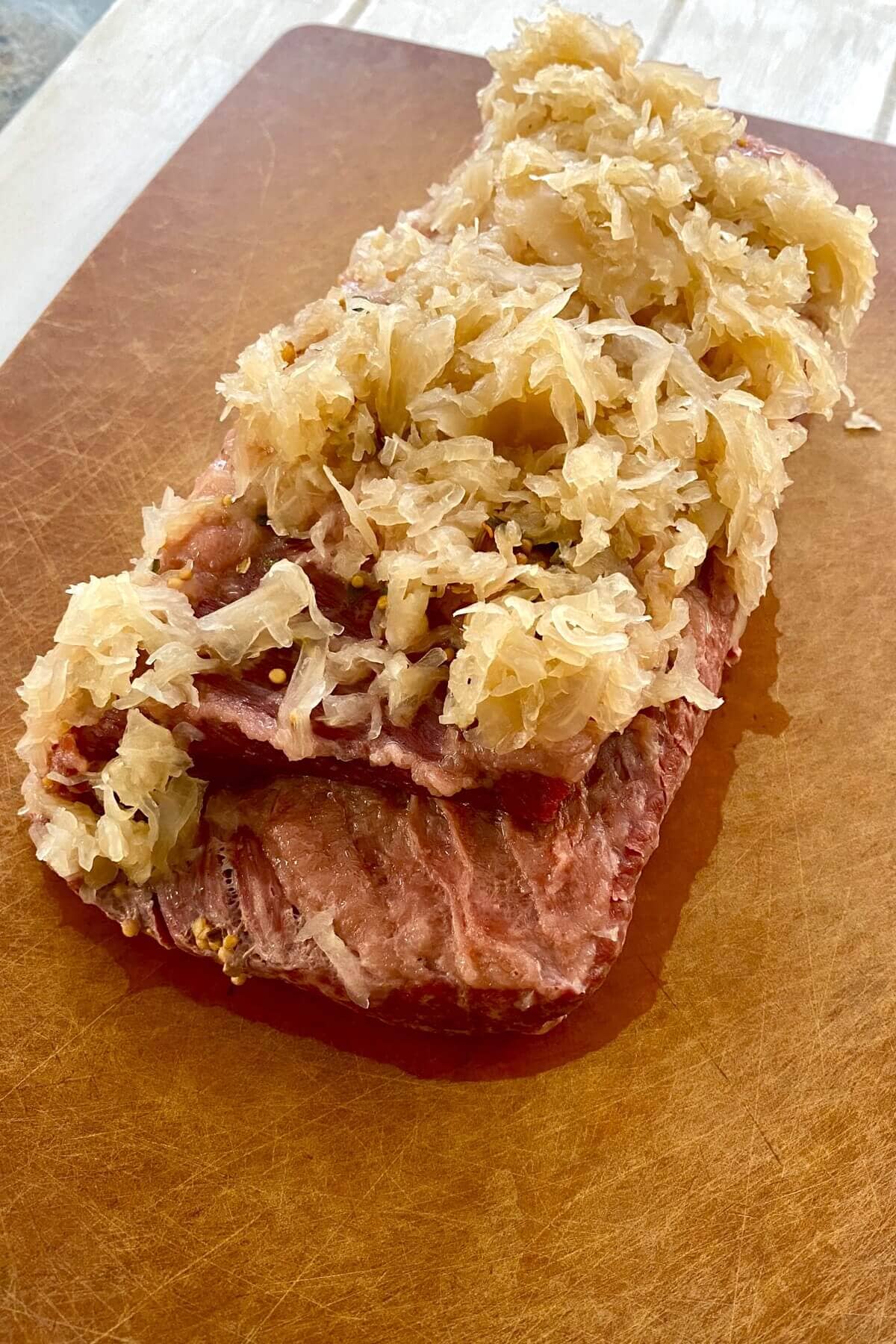 cooked corned beef on a cutting board.