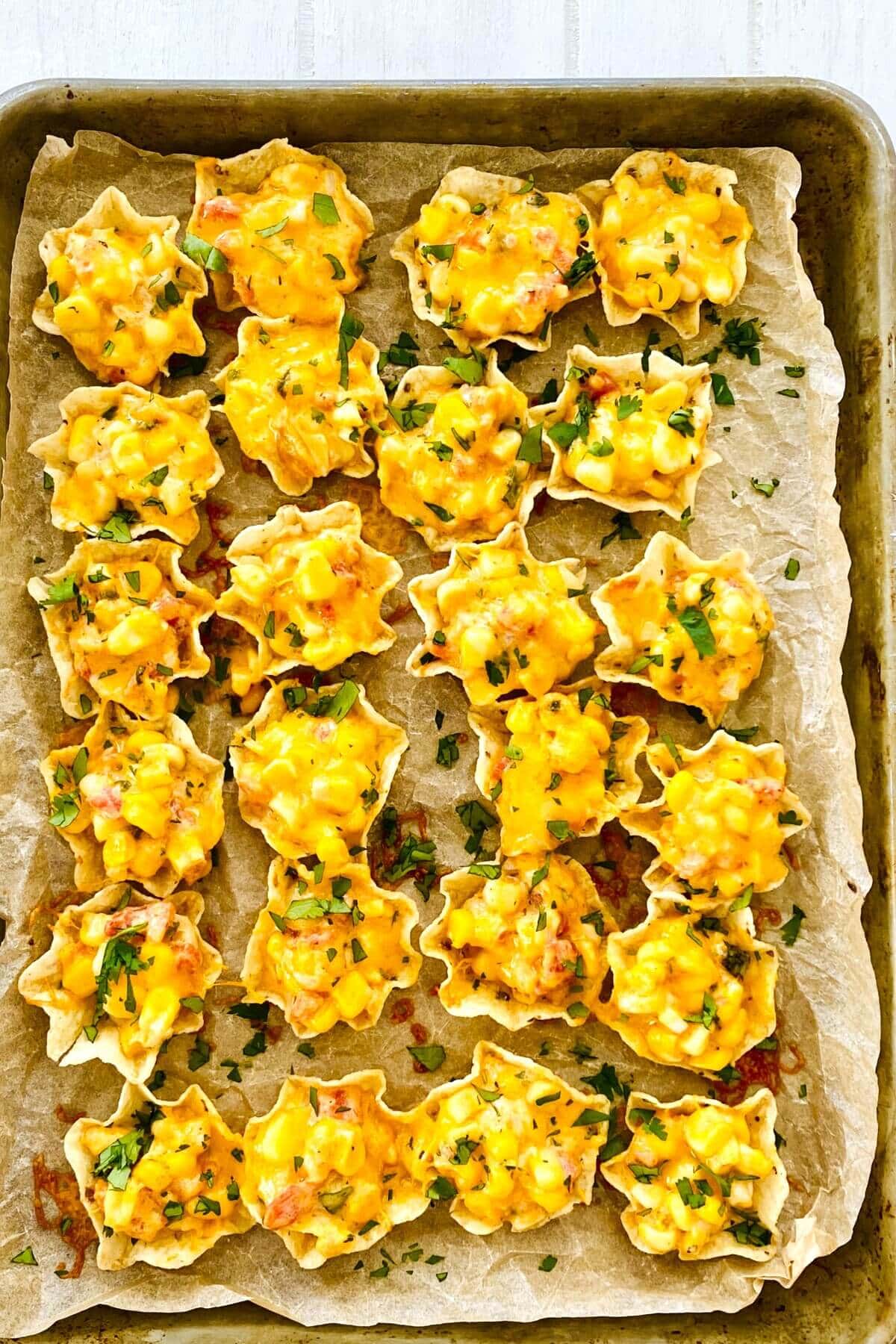 a sheet pan with Tostito Scoops with corn dip with cream cheese.