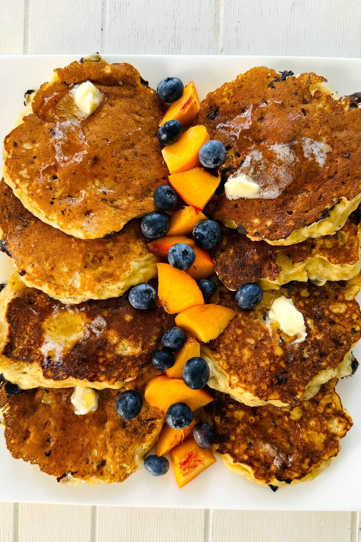 Cottage cheese protein pancakes with cut up fruit.