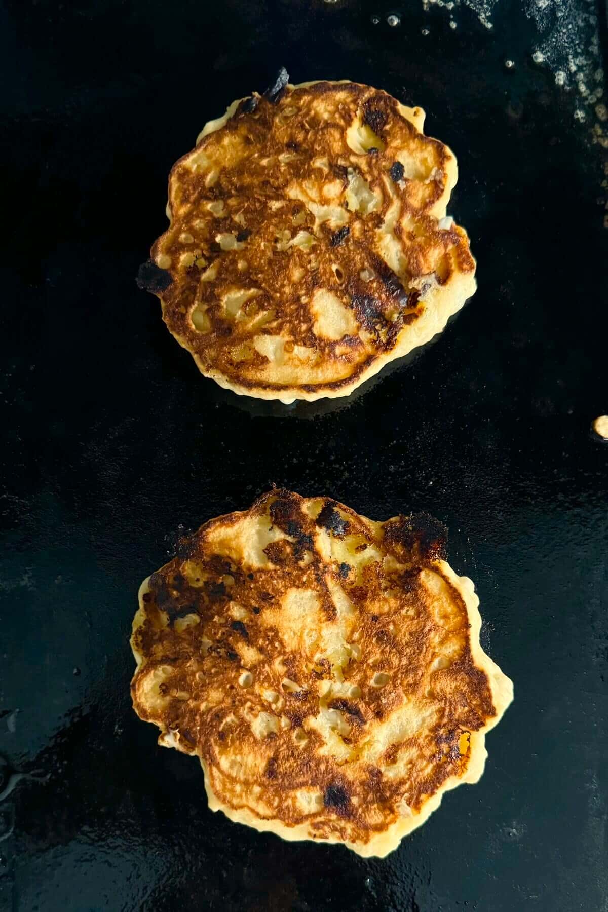 Cooked banana pancakes on a griddle.