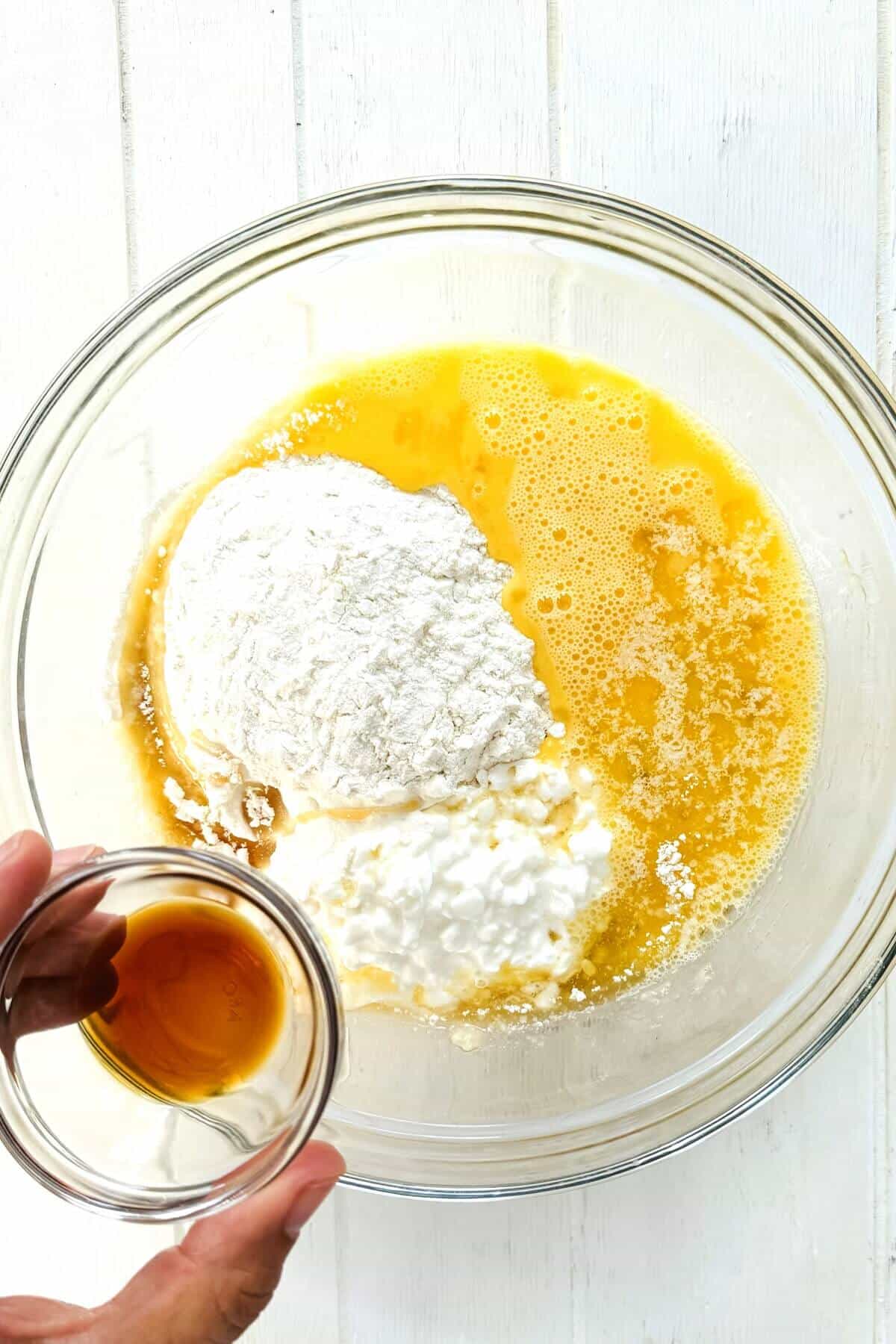 Vanilla being added to pancake ingredients.