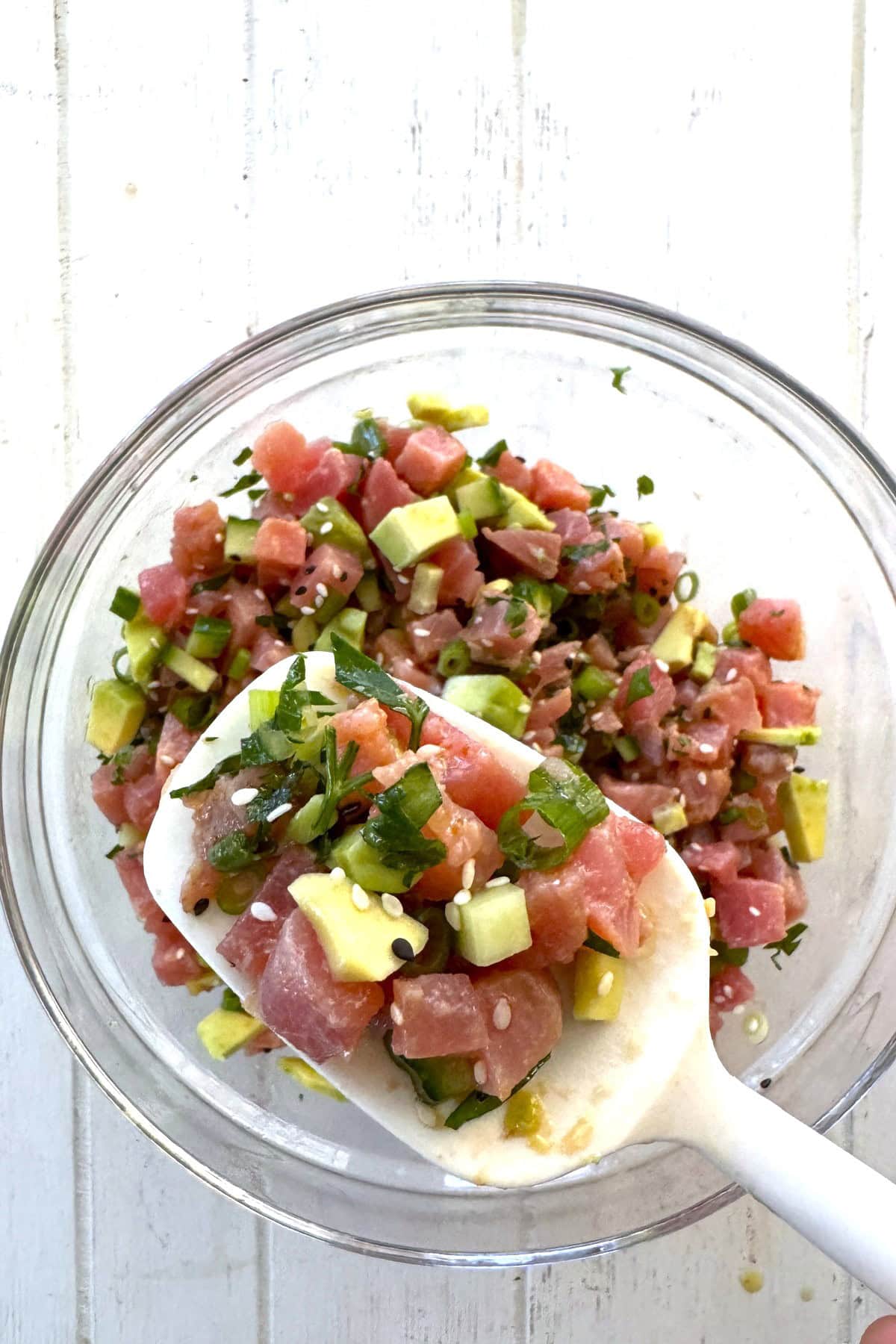 Raw tuna salad on a spoon.