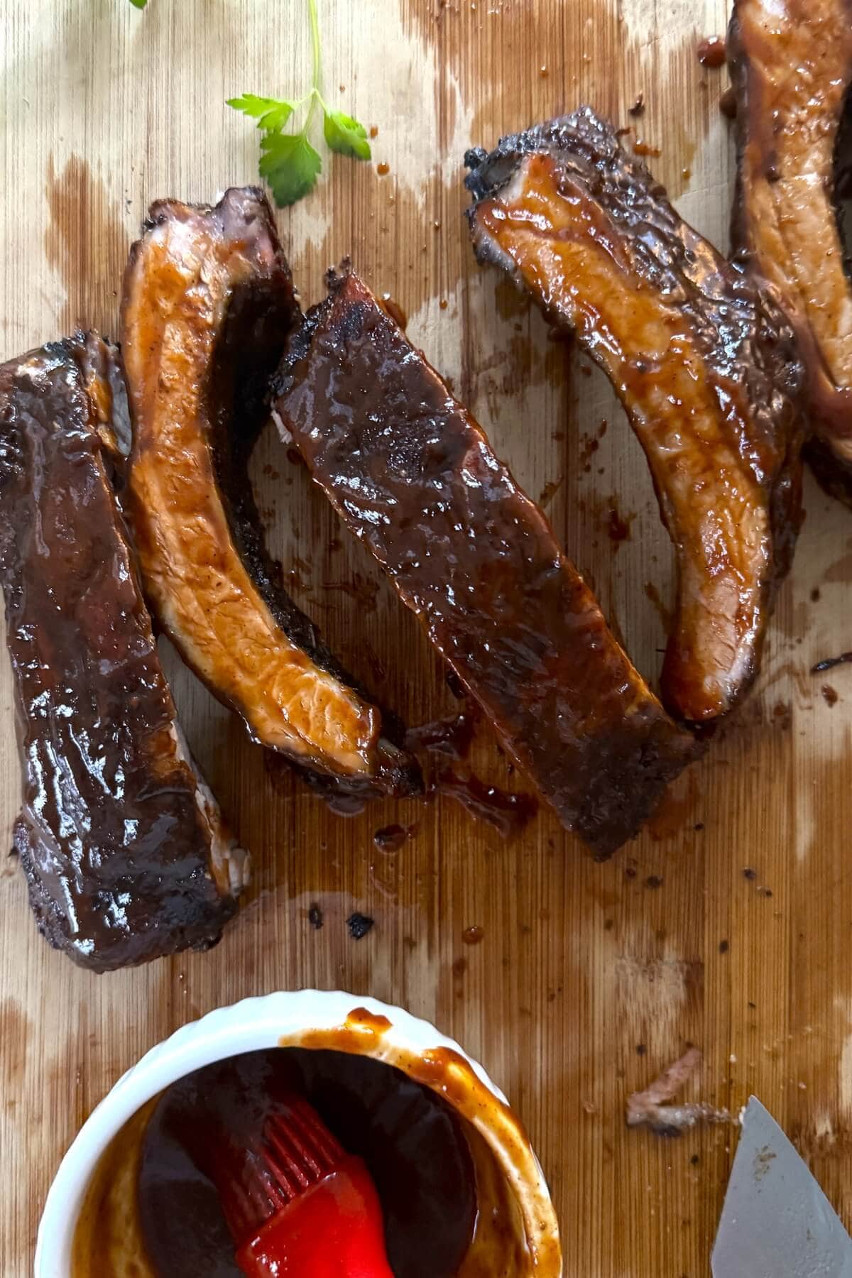Individual pork ribs with barbecue sauce.