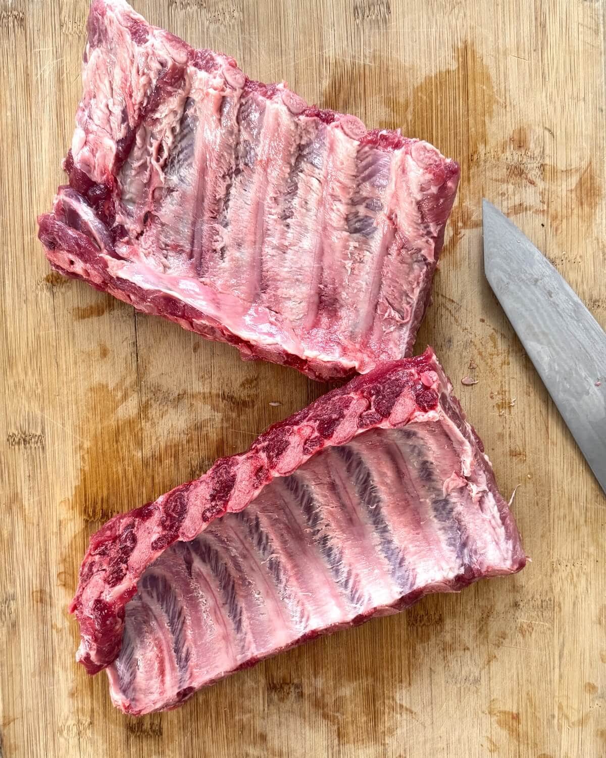 Baby back rib rack cut in half with membrane removed.