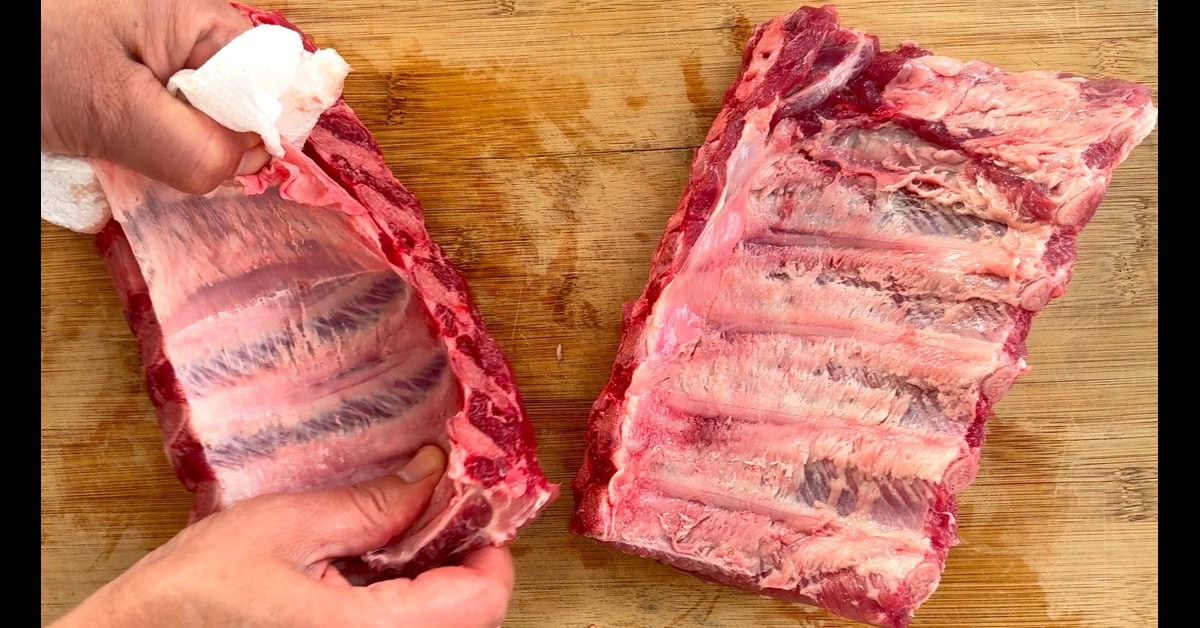 Removing the membrane from ribs.