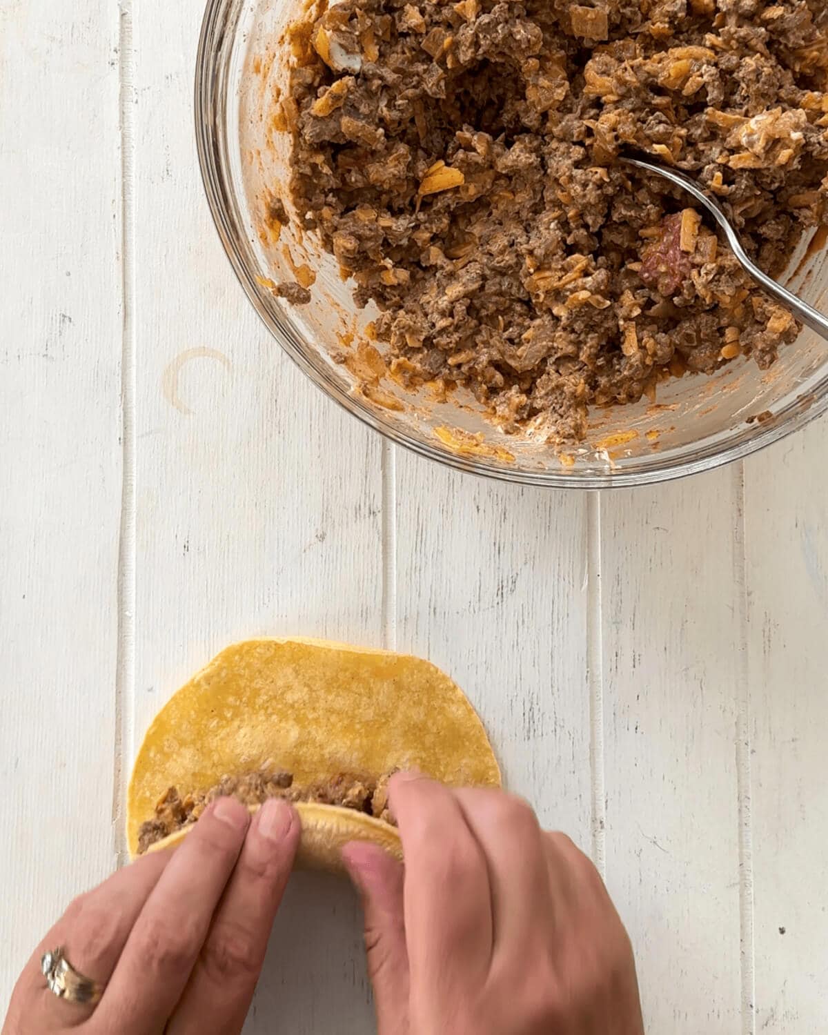 Rolling taquitos and a bowl full of filling.