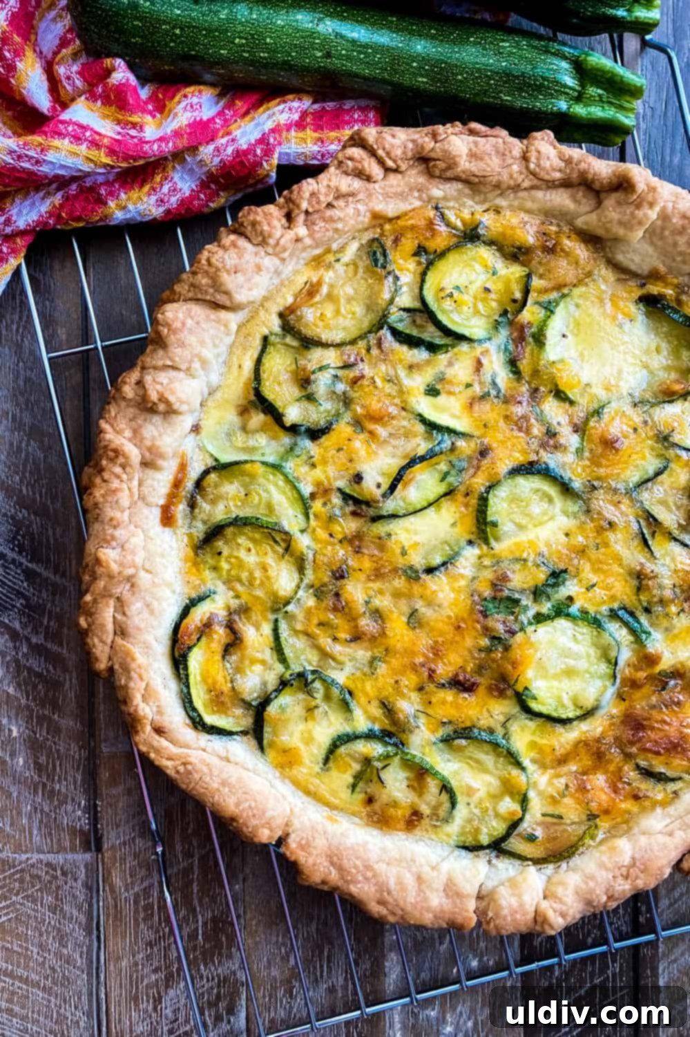 Herbed Zucchini Delight 2 A golden-brown savory pie, showcasing fresh zucchini slices and melted cheese, ready to be served.