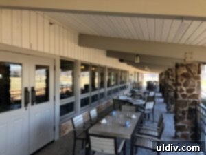 The elegant and spacious outdoor patio at Coarse Italian, offering serene views for al fresco dining.