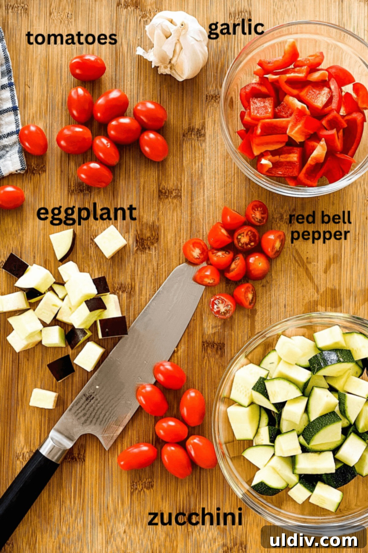 Effortless One-Pot Slow Cooker Ratatouille 4 Large diced eggplant, tomatoes, red peppers, and garlic, ready for cooking.