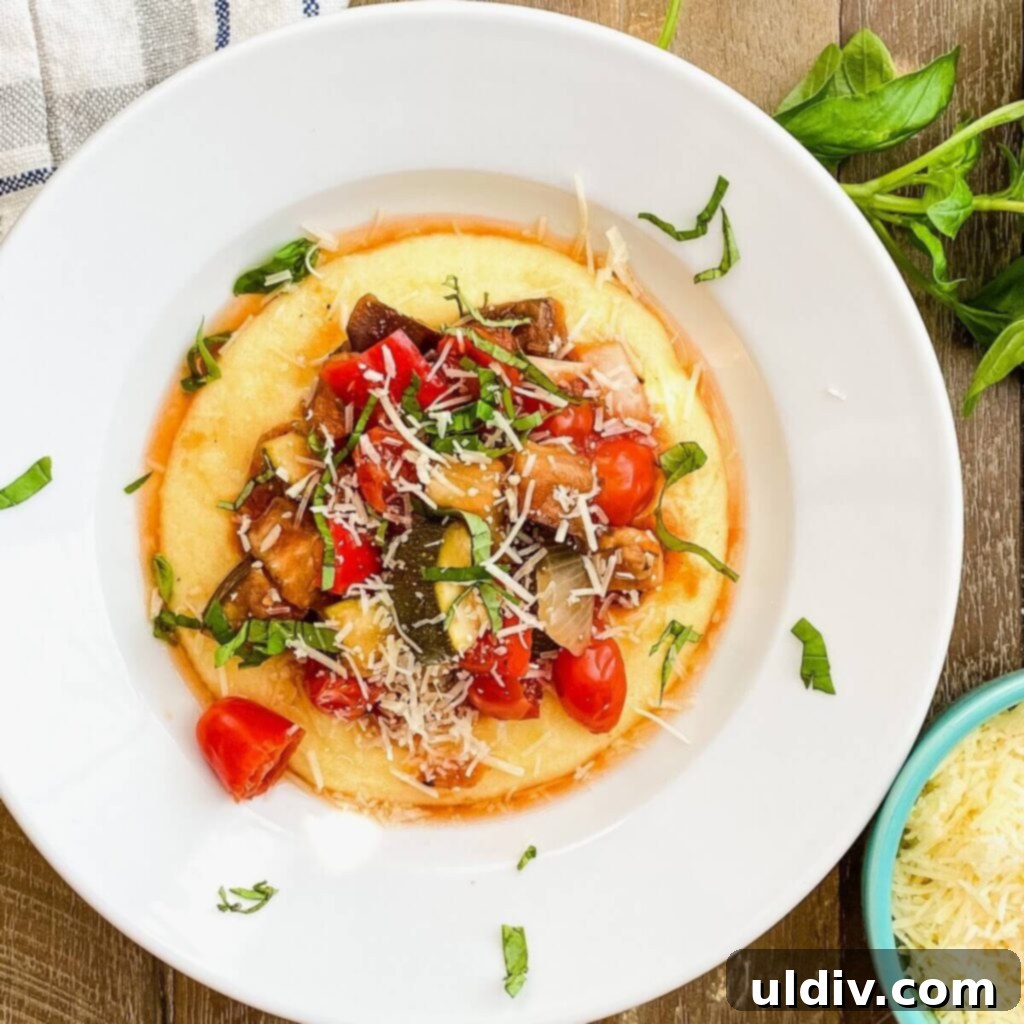 Crock pot ratatouille served over polenta with fresh basil garnish.