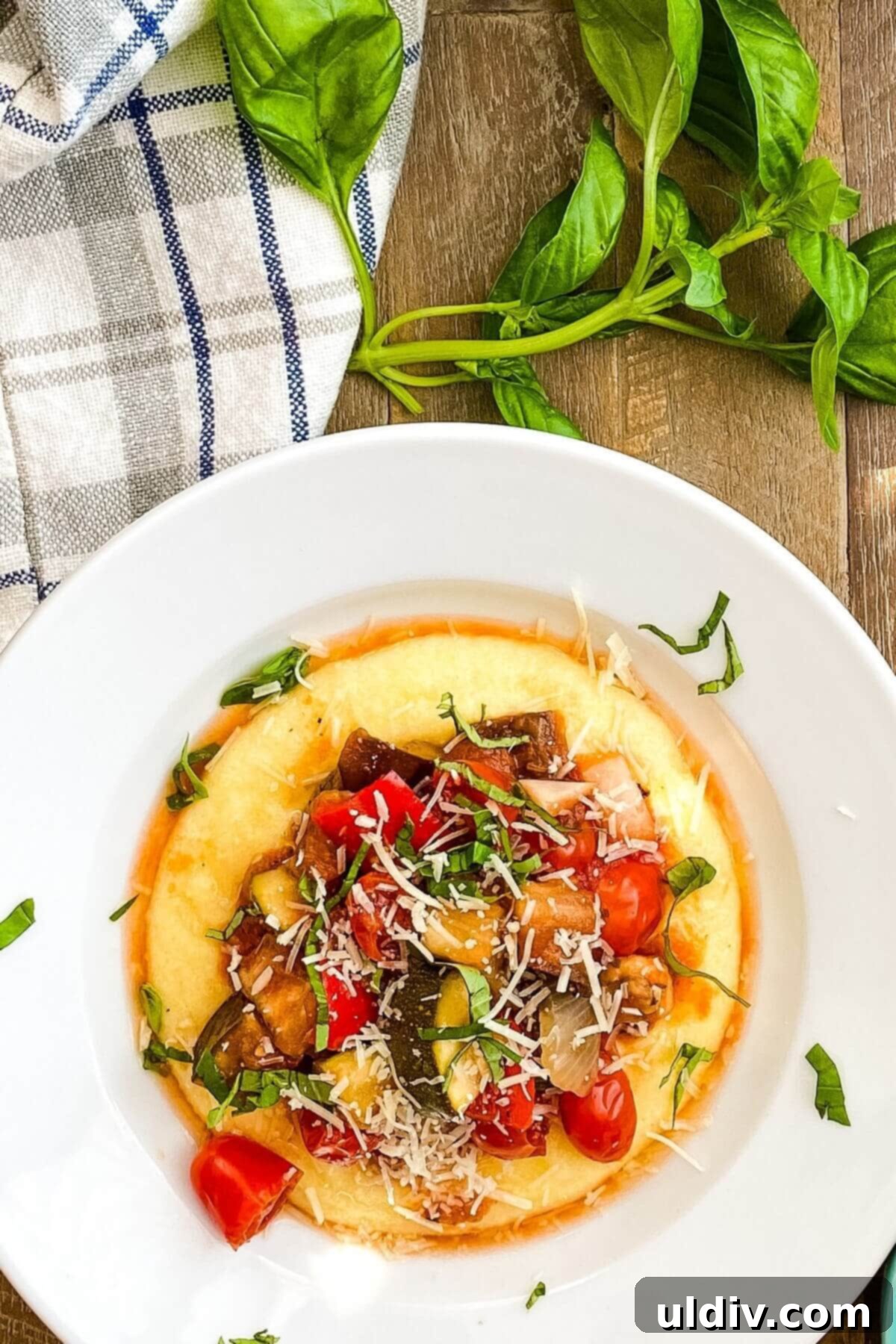 Effortless One-Pot Slow Cooker Ratatouille 9 A bowl with creamy polenta topped with slow cooker ratatouille.