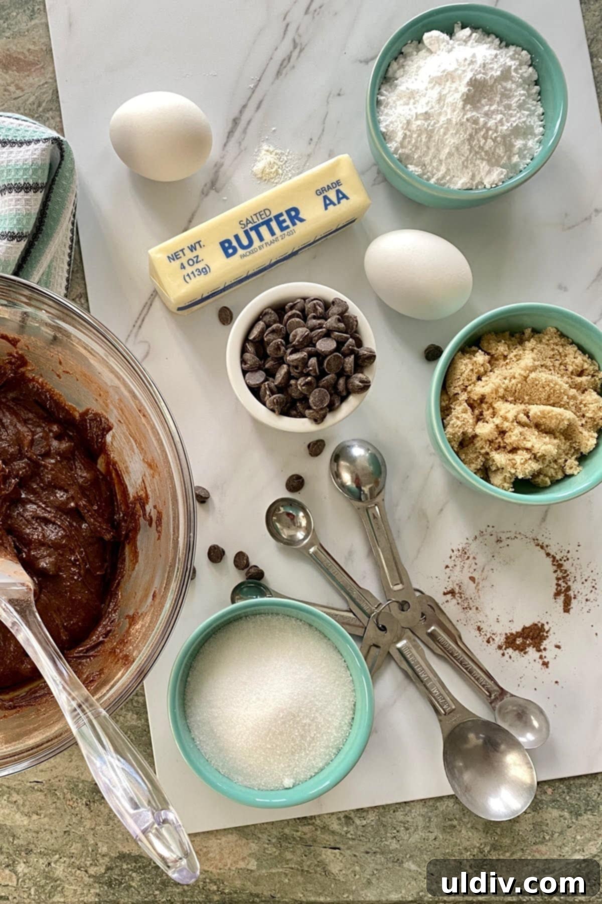 Fudgy and Decadent Mint Brownies 3 Ingredients for brownies: brown sugar, chocolate chips, egg, butter, and brownie batter in a bowl.