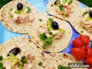 A Foldit flatbread being generously filled with the vibrant cream cheese and roasted red pepper mixture, ready to be folded into a delicious sandwich.