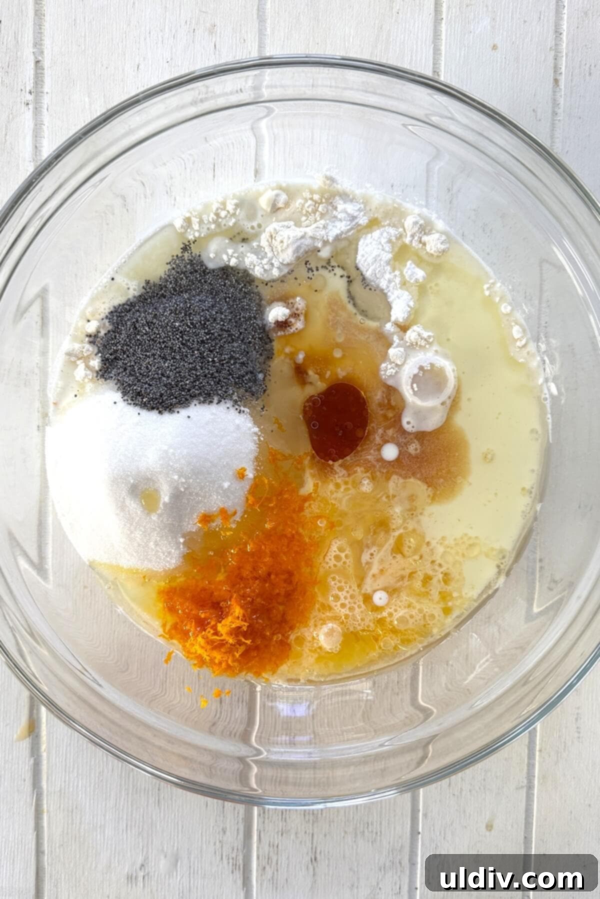 Sunshine Orange Poppy Muffins 6 All ingredients for orange poppy seed muffins in a large mixing bowl.