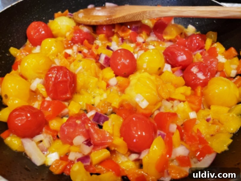 Evdeki Malzemelerle Yazlık Vegan Kuskus Salatası 4 Close-up of vibrant vegetables sautéing in a pan.