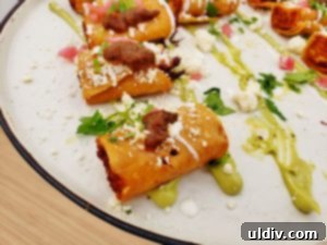 Crispy chicken taquitos served with lime sour cream, avocado, and charred tomato salsa