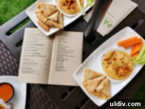 Mediterranean hummus with pita bread and colorful fresh vegetables
